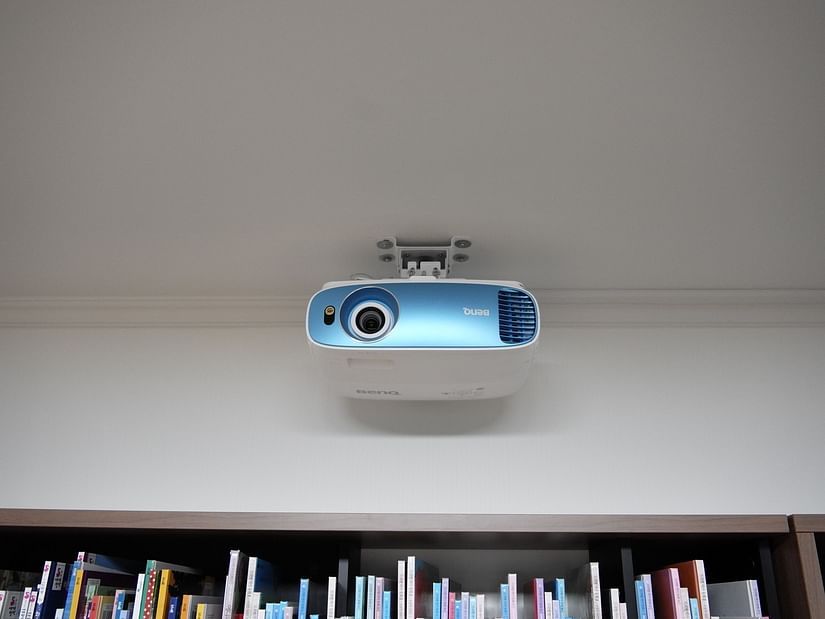A blue coloured wall mounted projector in our meeting hall - Stone Wood Nature Resort, Gokarna