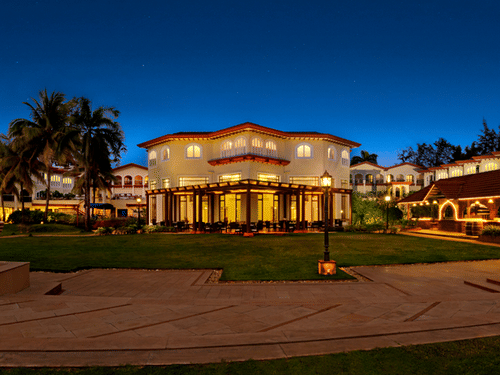 Evening view of Kenilworth Resort & Spa, Goa, showcasing the illuminated resort facade, landscaped grounds, and elegant architecture.