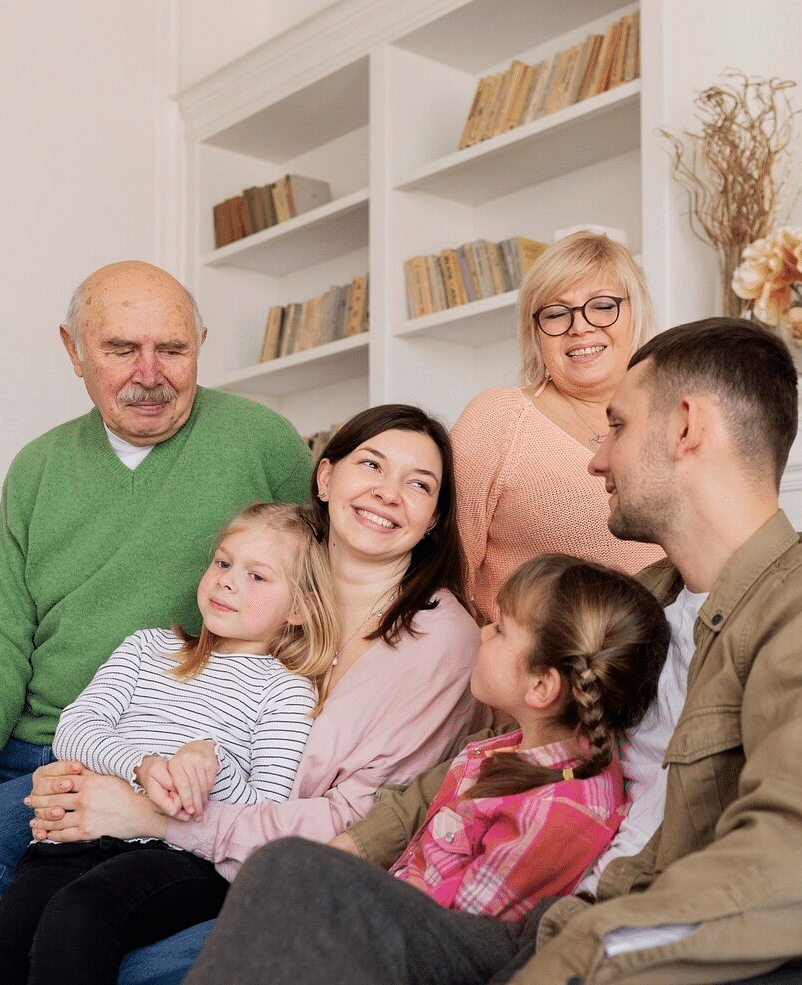 A group of people smiling at each other.