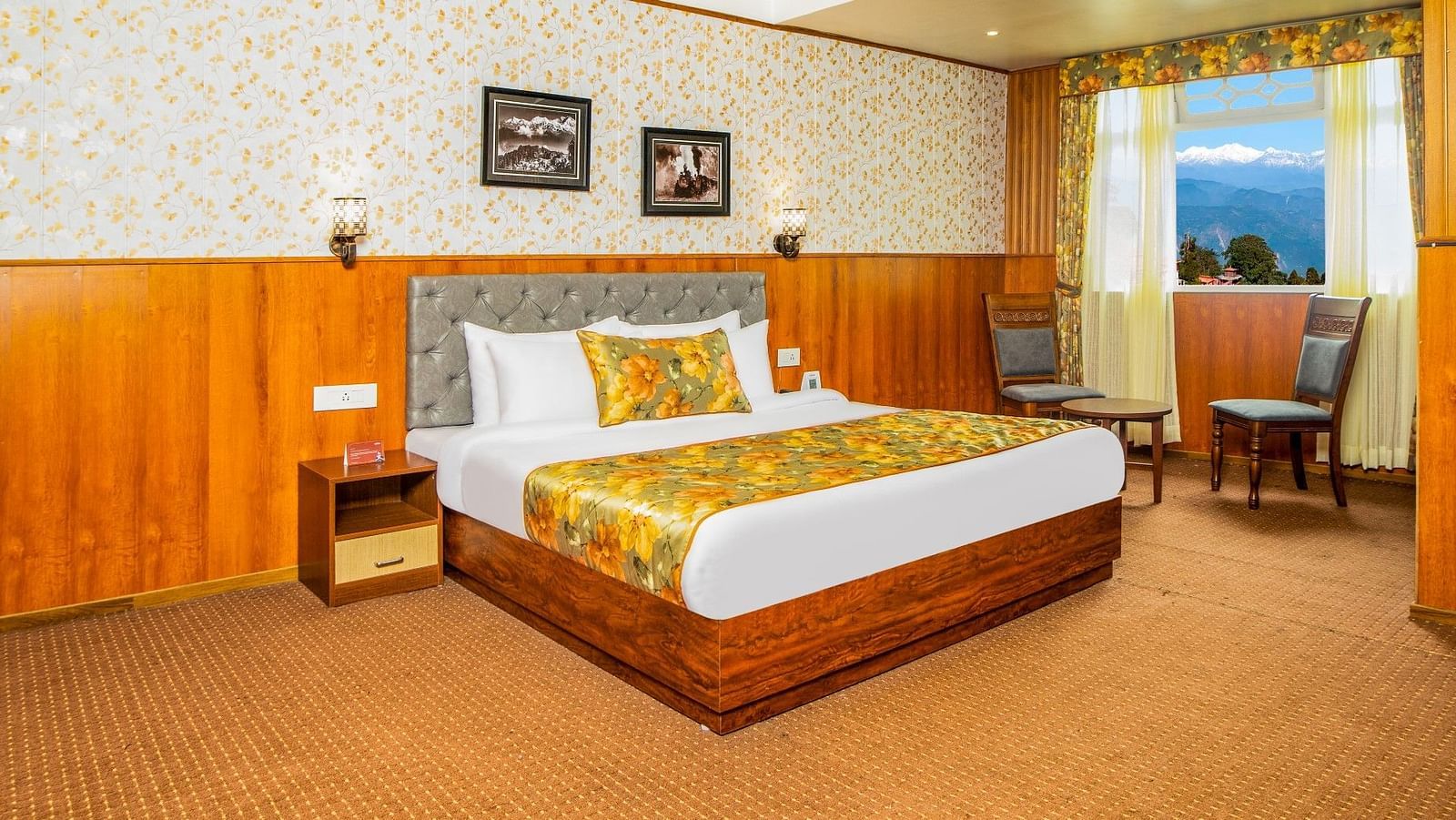 A bed in a room that has two chairs near the window | Summit Oakden Resort & Spa, Mall Road