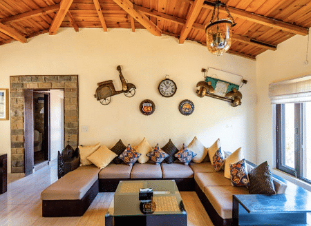 Cosy indoor lounge with wooden ceiling and ethnic decor elements at BluSalzz Collection - Suvaasa Resort, Ramgarh.