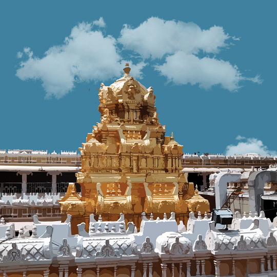 A golden temple gopuram with intricate carvings and statues against a cloudy blue sky.