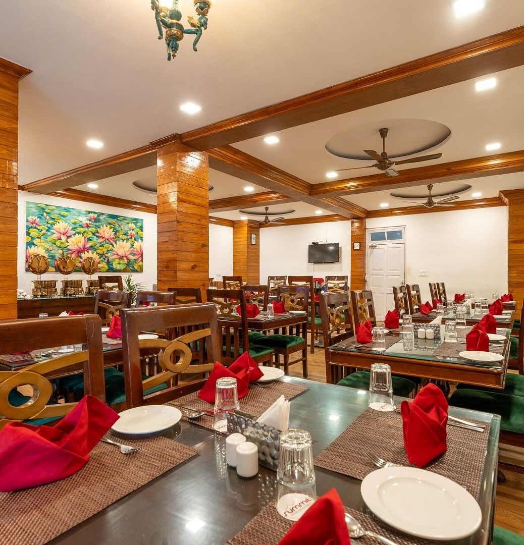 Dining arrangement in the restaurant at Summit Barsana Resort & Spa, Kalimpong