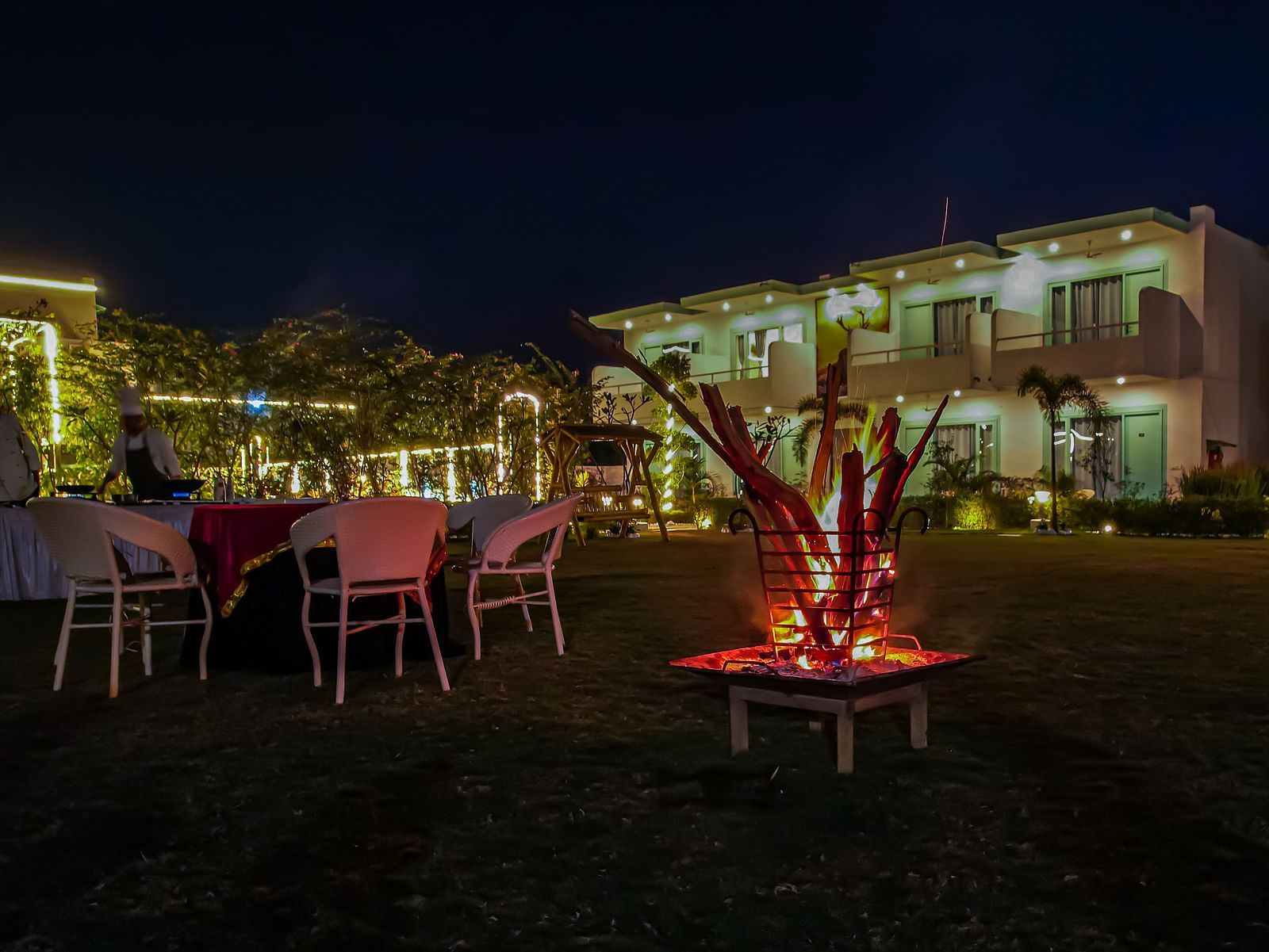 Bonfire setup with chairs around on the lawn, creating a cosy evening atmosphere at Vedikant Resorts The Mallard Corbett.
