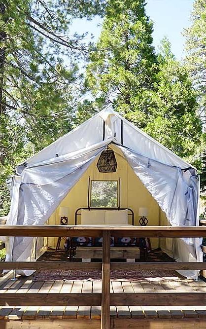 Exterior of a tent surrounded by trees at Shaver Lake Village Hotel.