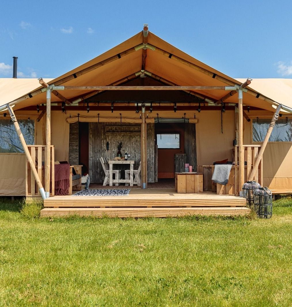 An overview of a glamping tent placed on a manicured lawn area - WoCAL Retreat Ke Ga