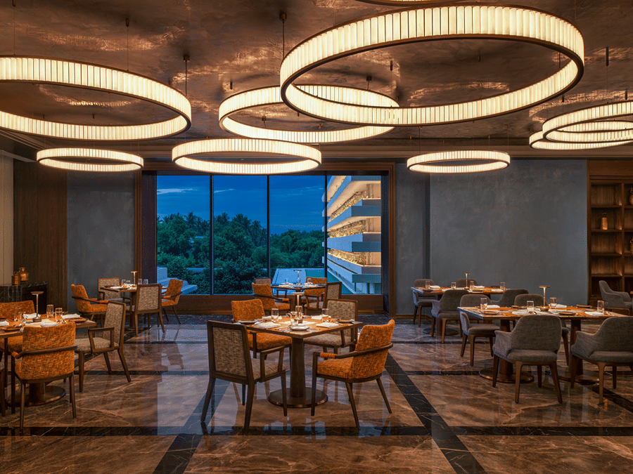 Grand Trunk restaurant seating area with circular pendant lighting at The Residency Signature Madurai.