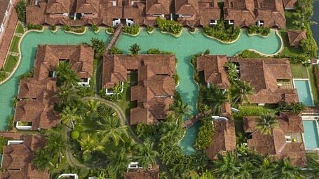 A drone shot of Kumarakom Lake Resort beside a lake