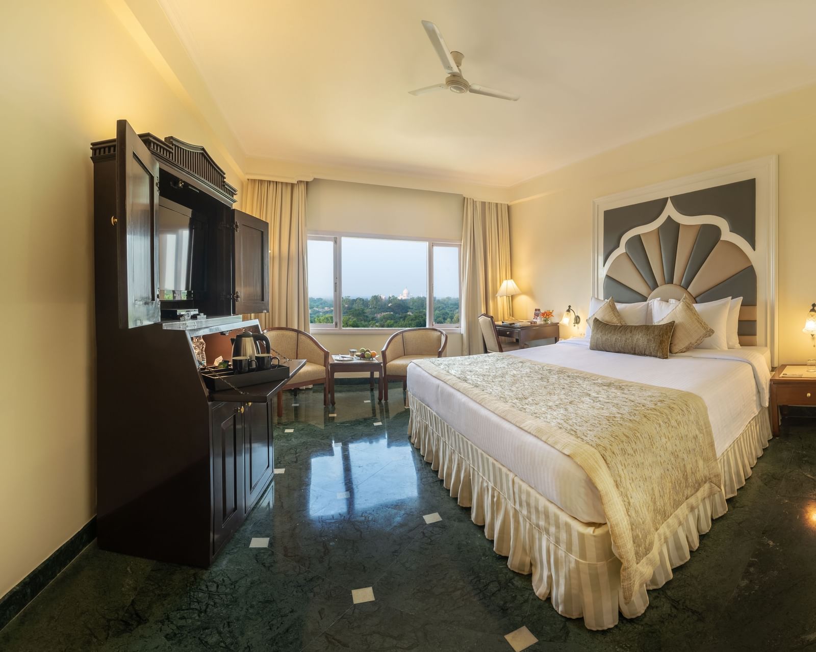 An overview of the elegantly designed rooms near the Taj Mahal at Hotel Clarks Shiraz, Agra, featuring a cosy double bed and stylish side tables.