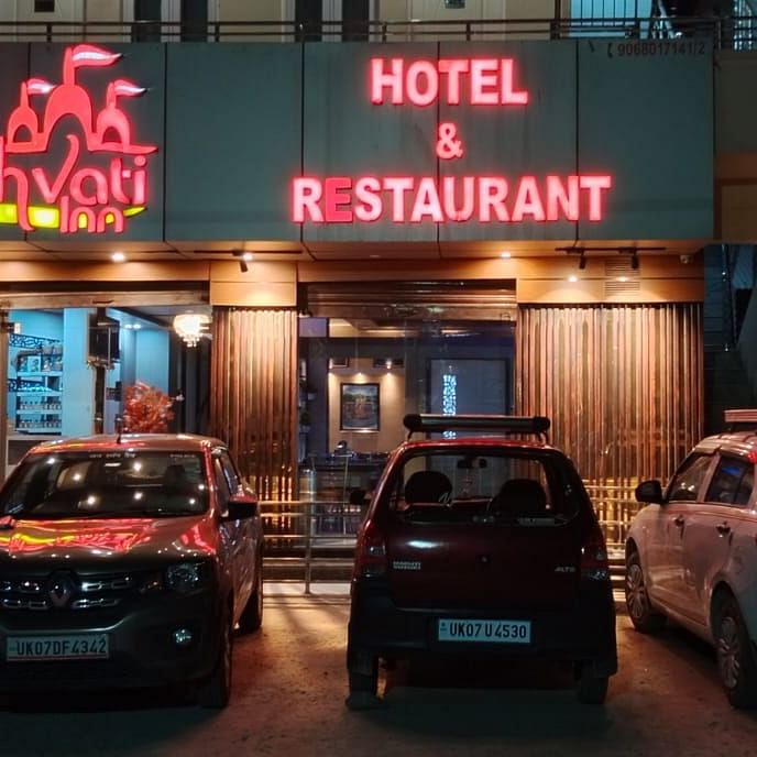 Facade of Hotel Panchvati Inn with cars parked outside