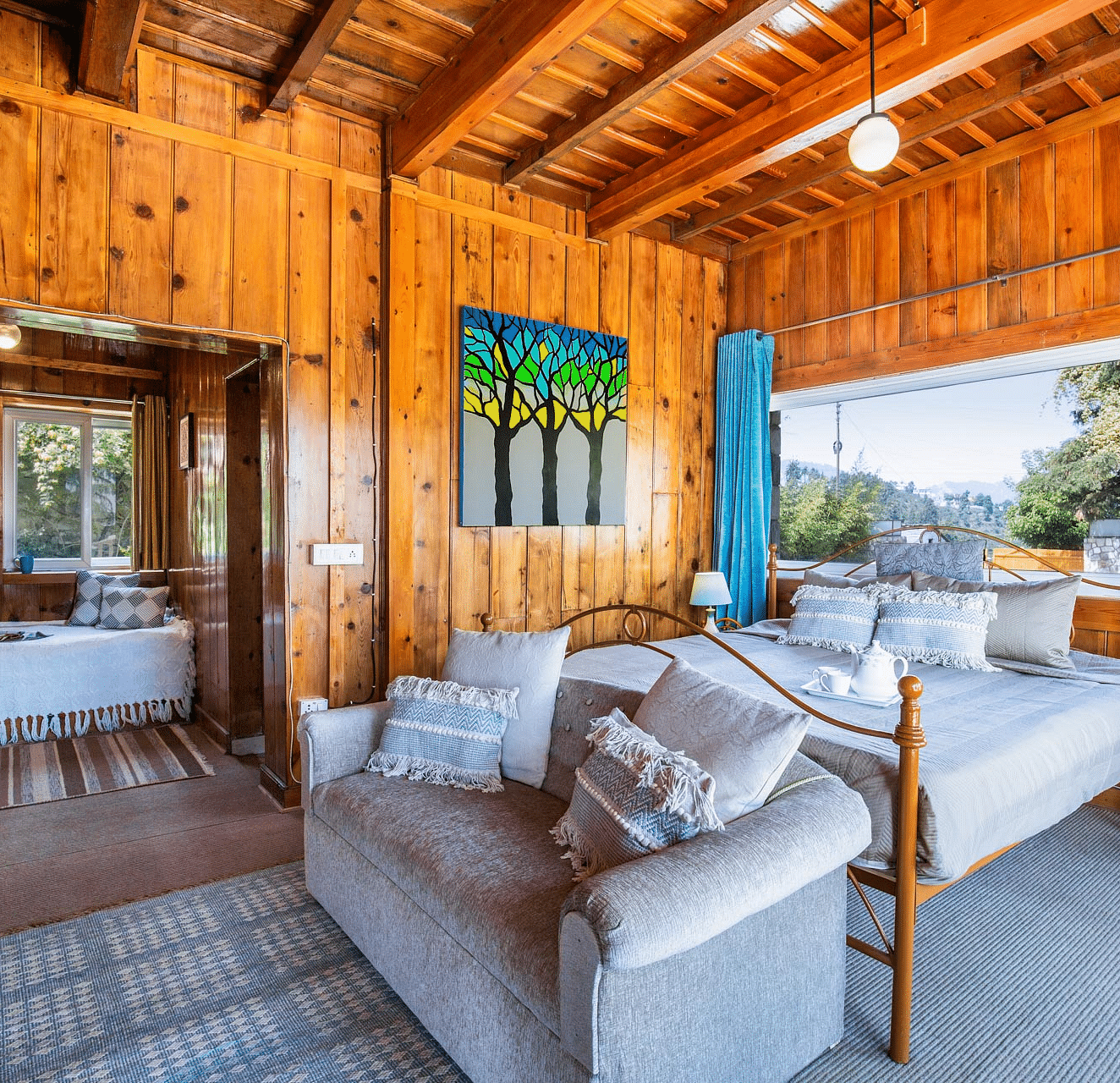 An mage of a master suite bedroom at avalon cottages with a seating arrangements near the window