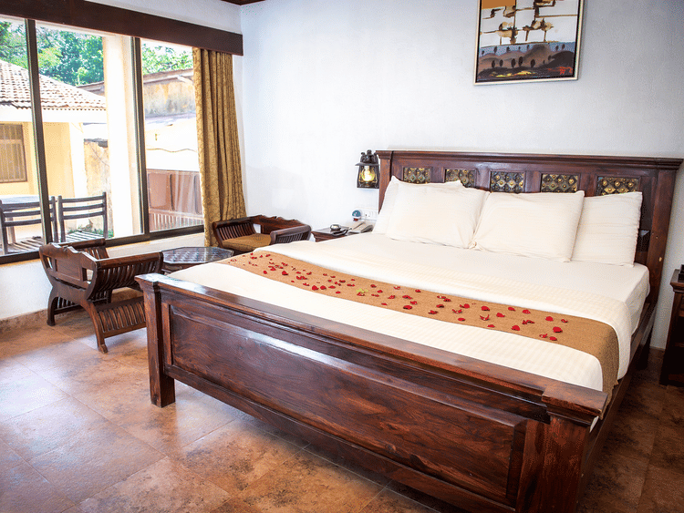 Adamo The Village - the balcony beside the king size bed offered at the Super Deluxe rooms in Matheran