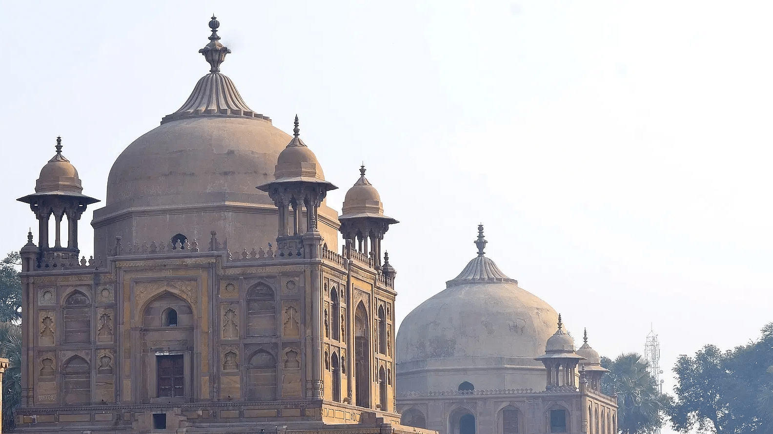 Historic mausoleum complex with domed architecture and garden.