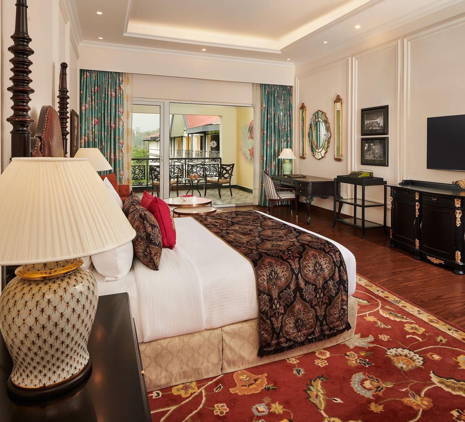 Classic bedroom with cosy lighting, elegant furniture, and large windows.