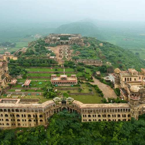 Aerial view of Tijara Fort-Palace - 19th Century, Alwar surrounded by greenery.