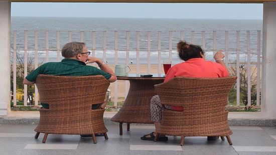 a couple sitting at our rooftop lounge in Mandarmani