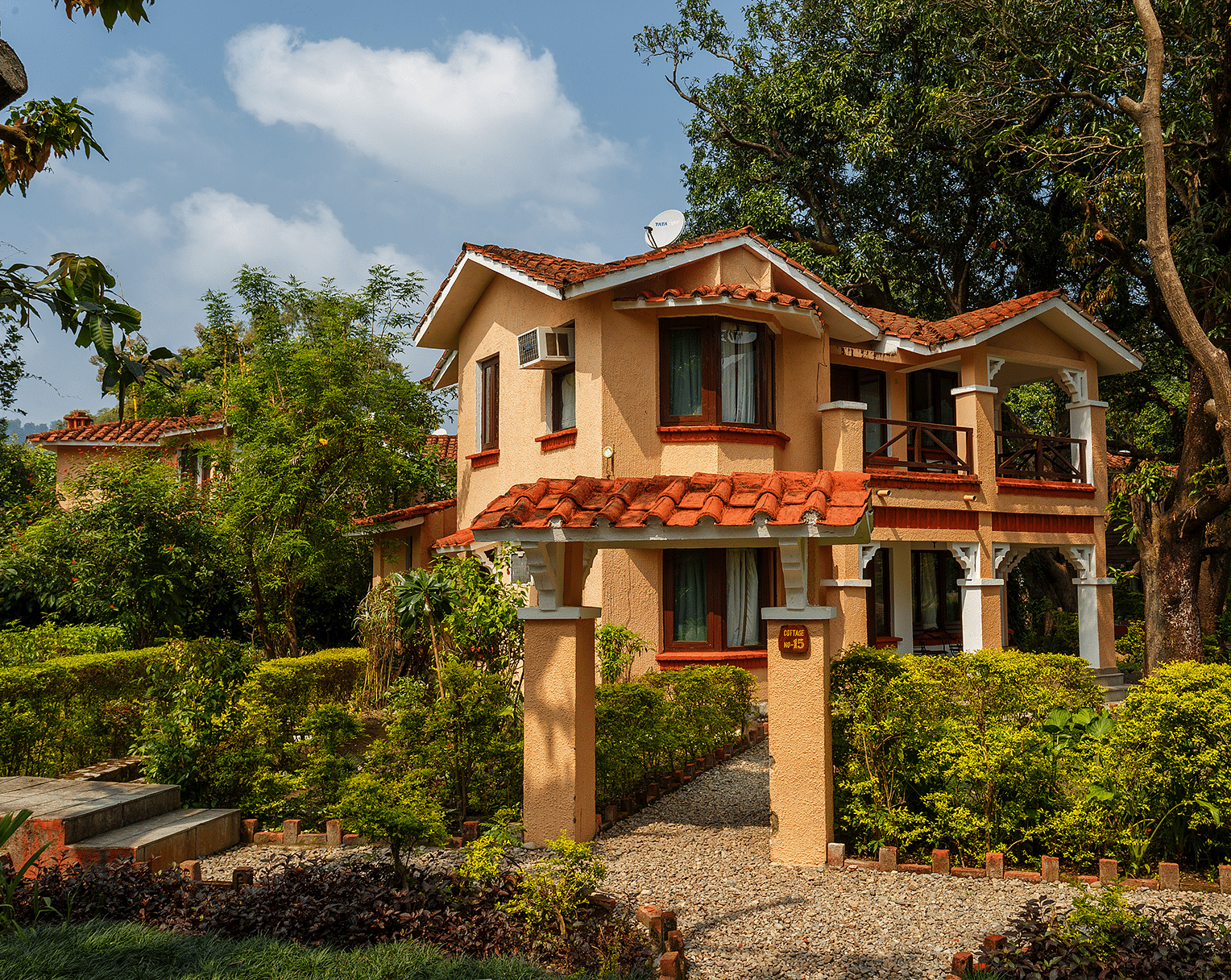 An image of a building with trees around in the day time