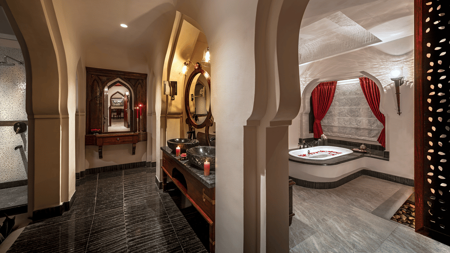Heritage-style luxury villa bathroom with arch detailing at Evolve Back Hampi