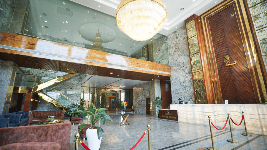 A wide-angle shot of the expansive lobby area with a reception desk in the corner at Leroy Grand, Yeshwanthpur.