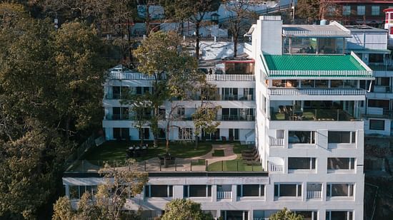 An aerial view of a building with trees around | Sumi Yash Shree Hotels & Resorts