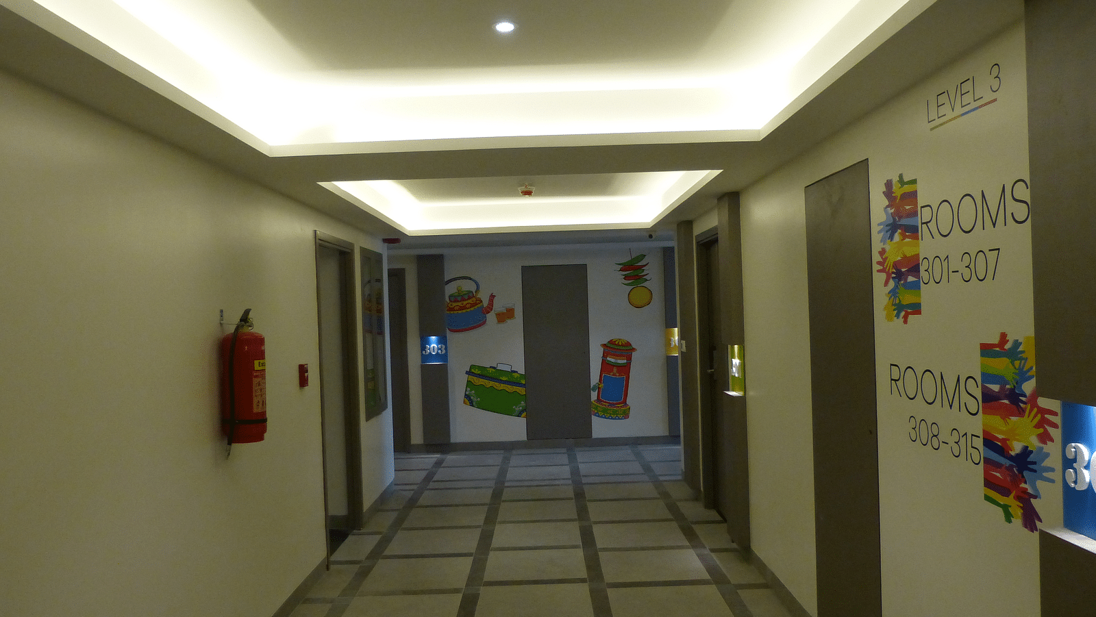 A corridor with ceiling lights illuminating the space