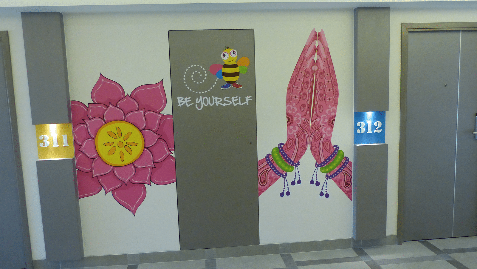 A painting near the lift wall shows flowers and hands joined in a gesture of greeting