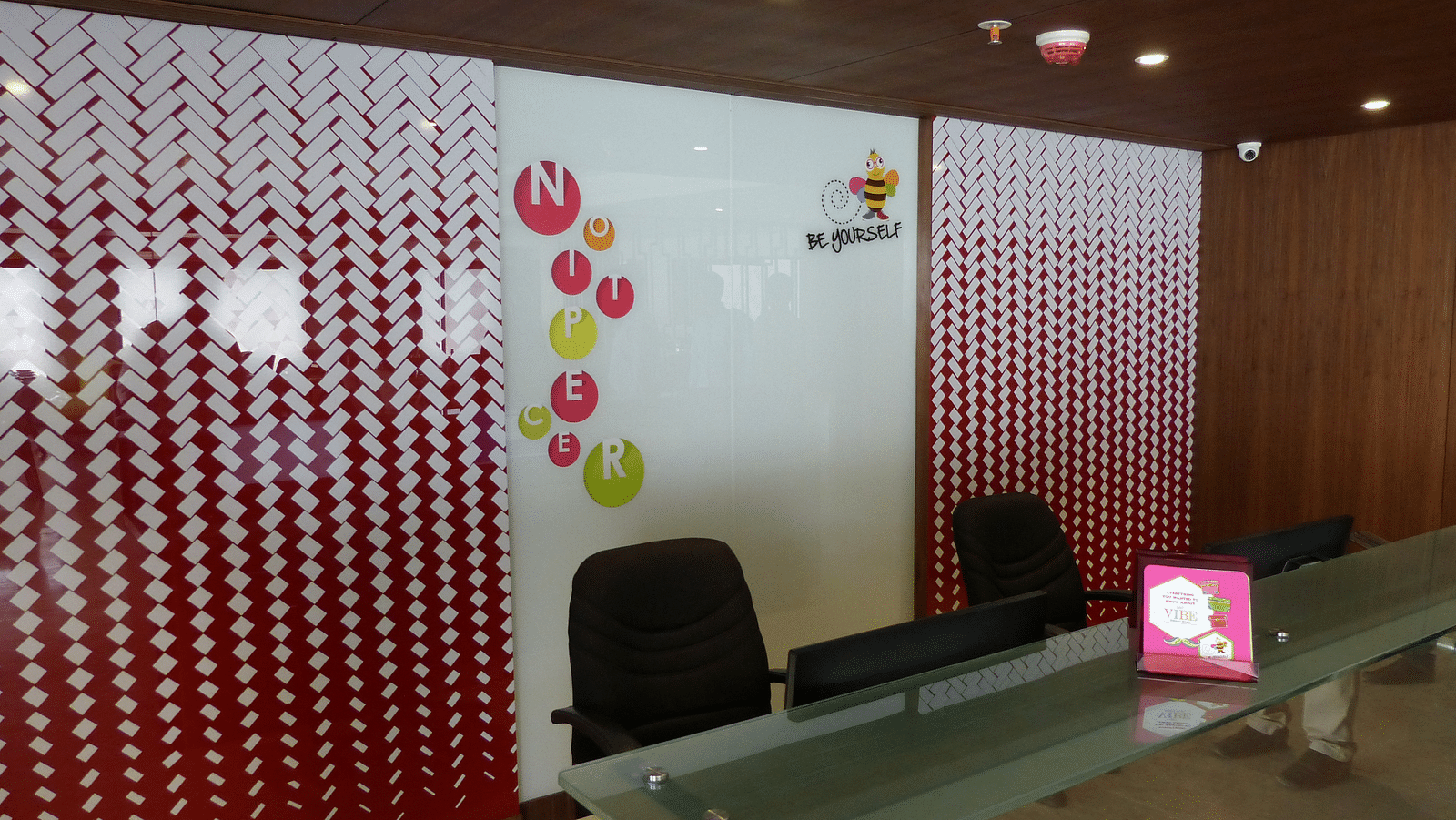 The reception area features a desk with chairs arranged neatly around it