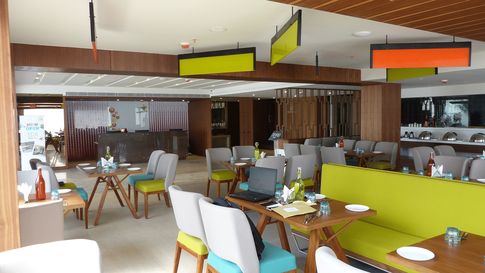 The dining area is set up with tables and chairs arranged neatly for the guests
