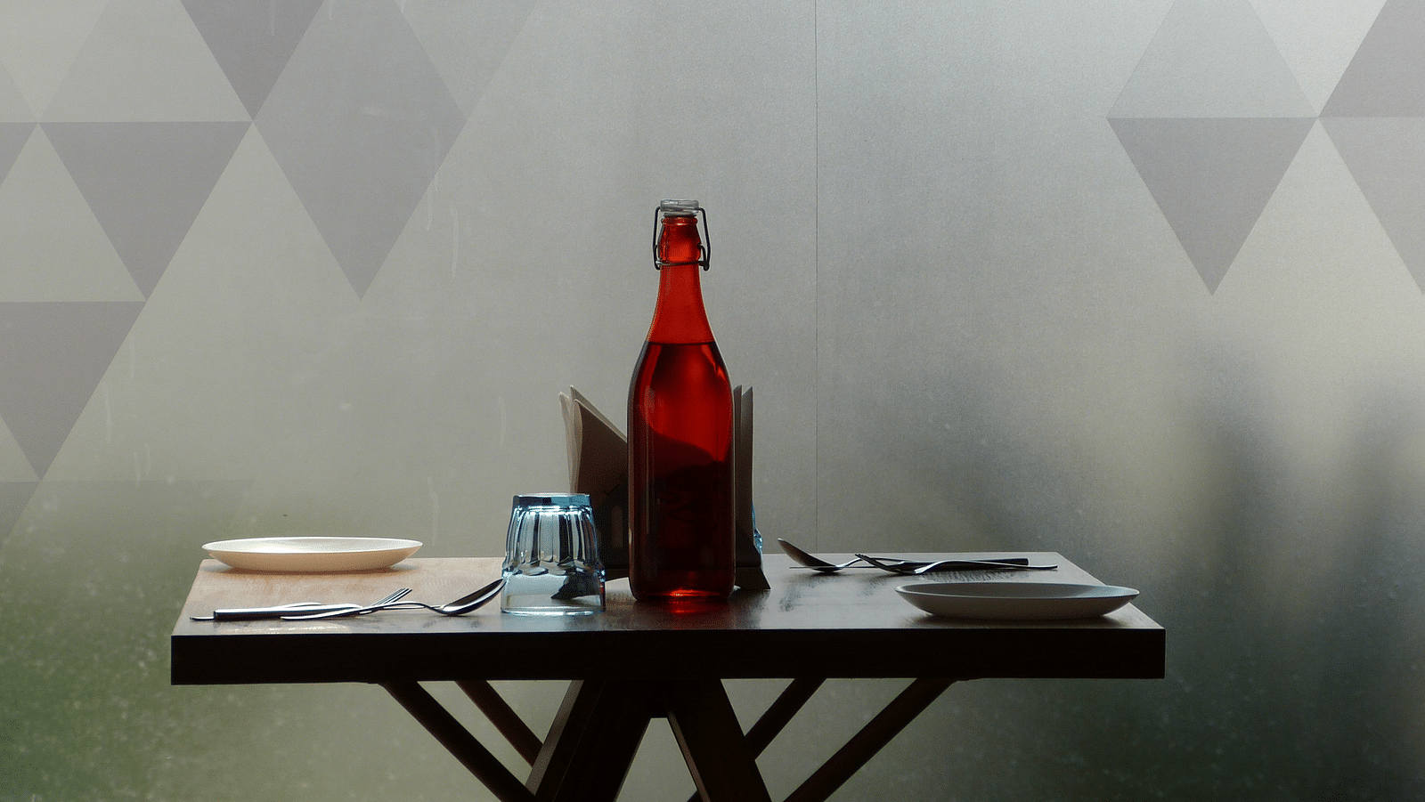  The dining area table is neatly set with cutlery, ready for the guests