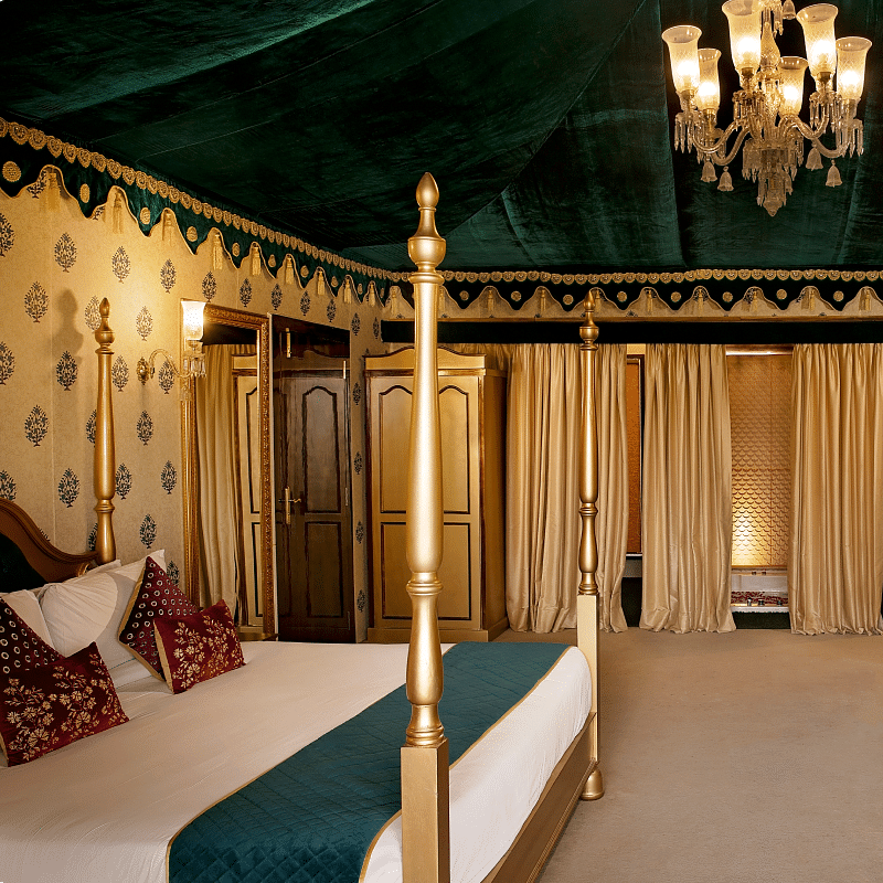 Side view of a room with a bed and a seating area in front at Rajasthali Resort & Spa Jaipur.