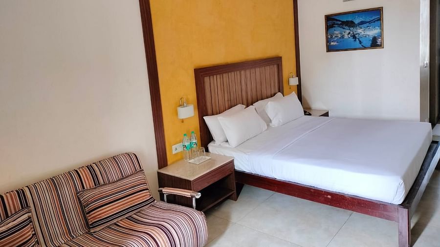 An image of bedroom with a bedside table, and a sofa next to it - VITS Lonvala