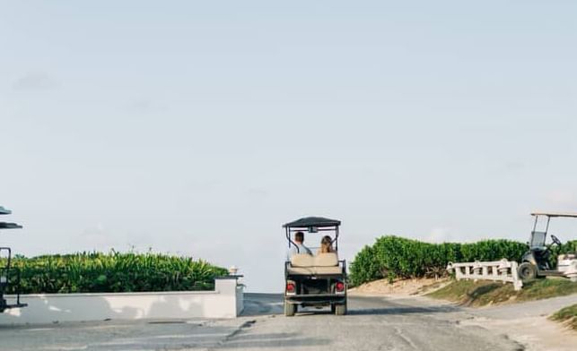 Road or pathway leads to a pier at Abaco Inn, open sky and water in the background.