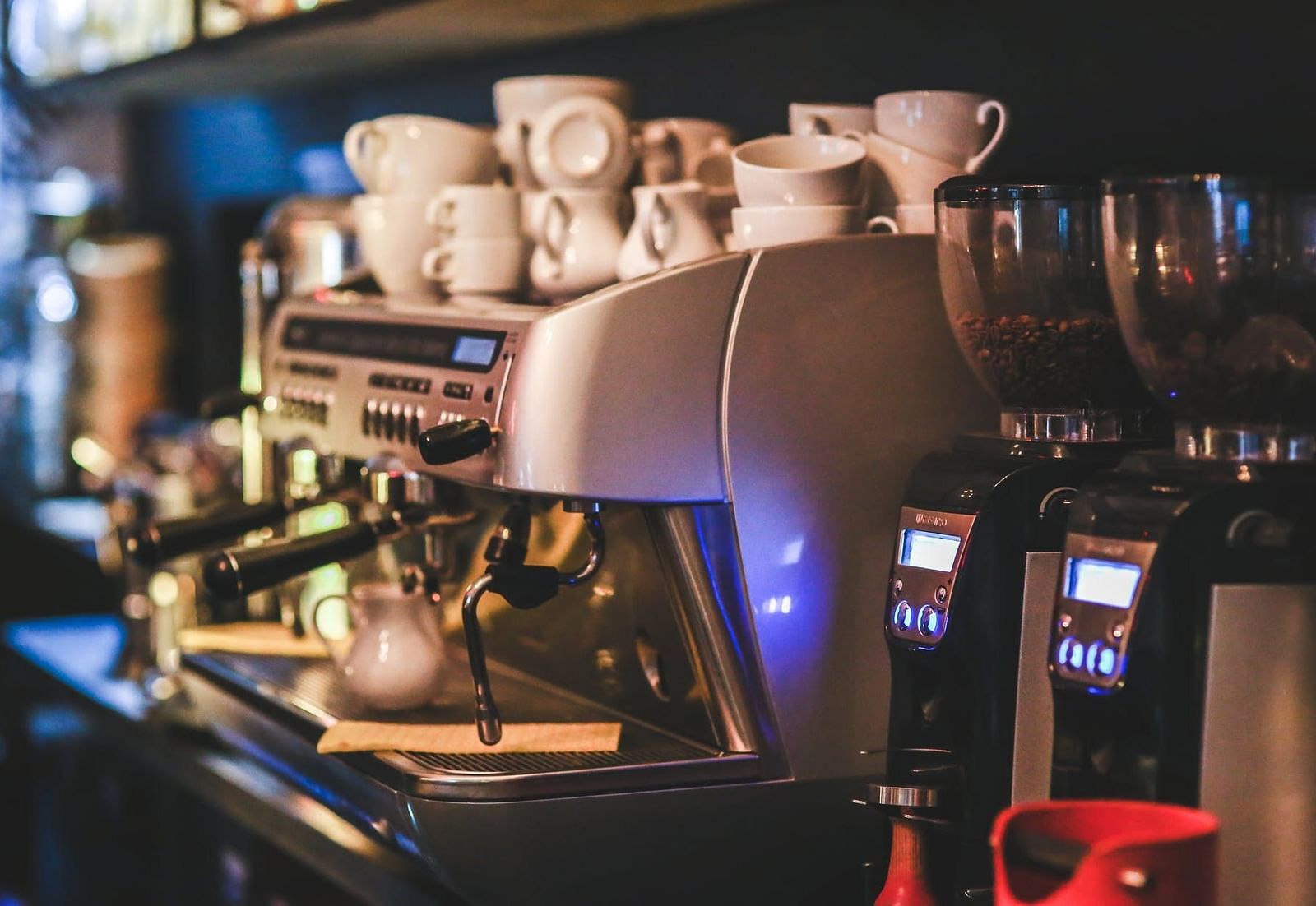 Image of a coffee machine with cups placed on top of it.
