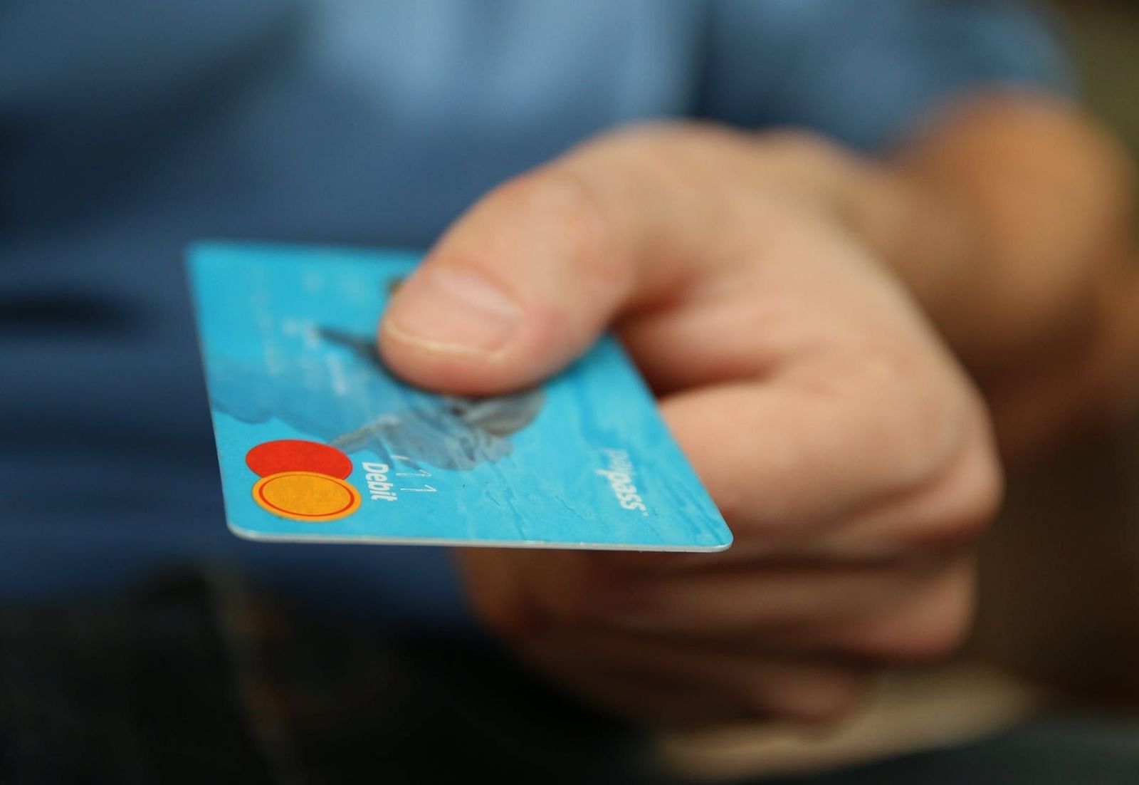 Image of a hand holding a card.