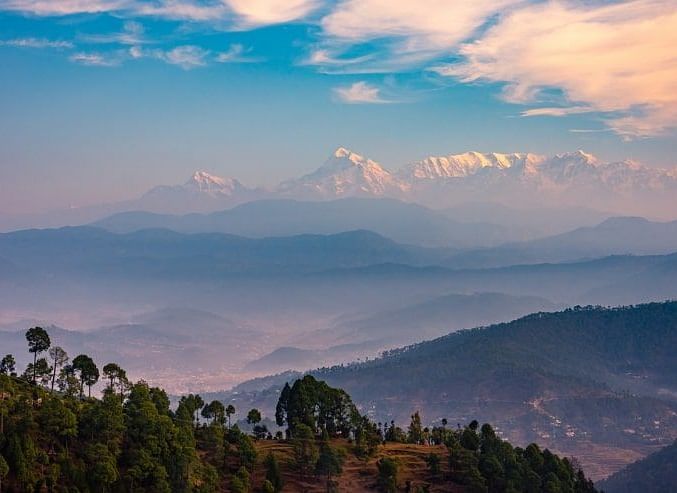 Scenic view of mountains surrounded by lush greenery.