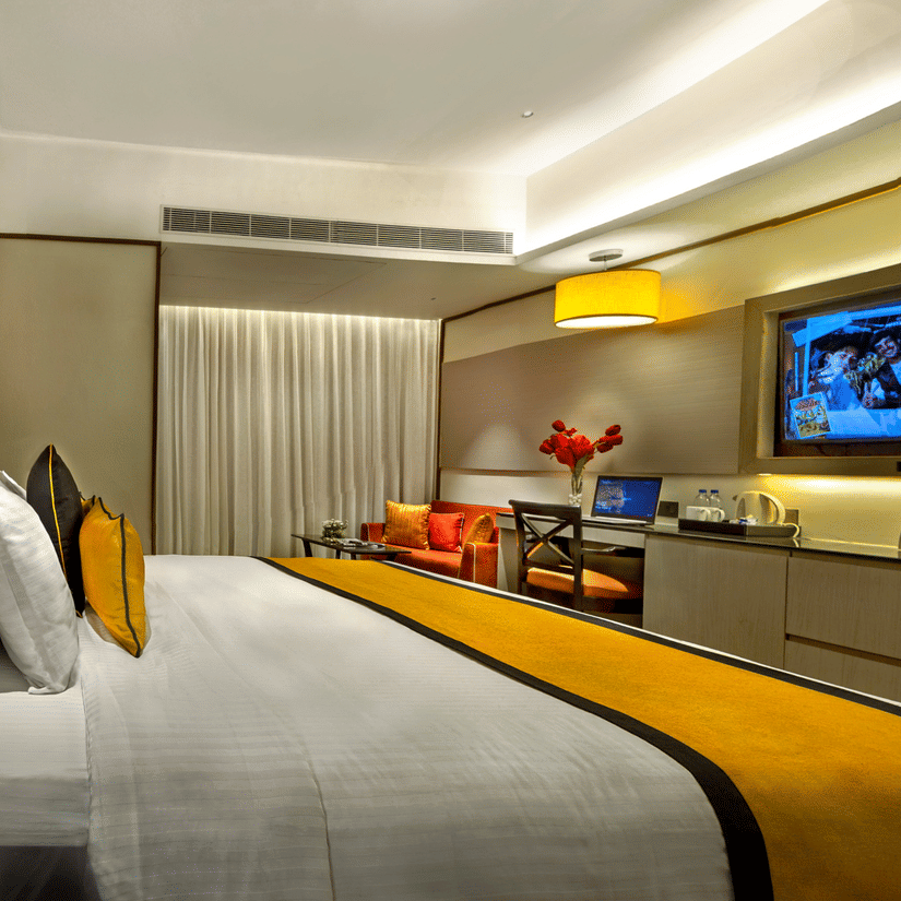 Spacious king room with elegant decor, seating area and smart TV at The Sonnet, Jamshedpur.