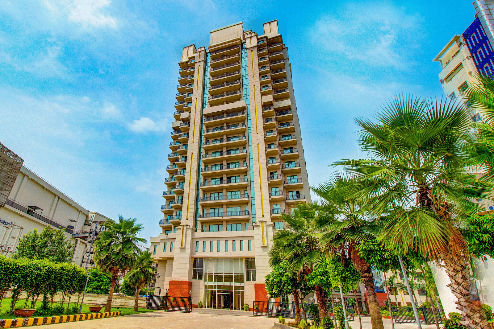 Facade view of the Entrance with trees in view at Rhythm Gurugram.