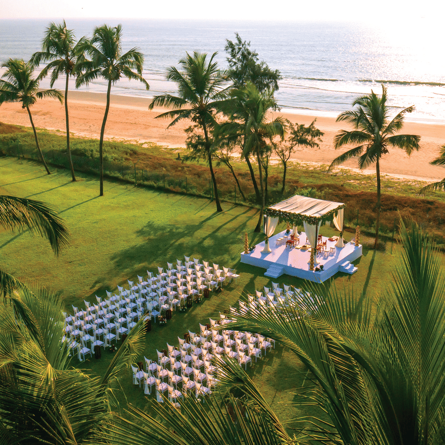 aerial view of a wedding with a stage and chairs in view - Caravela Beach Resort Goa.