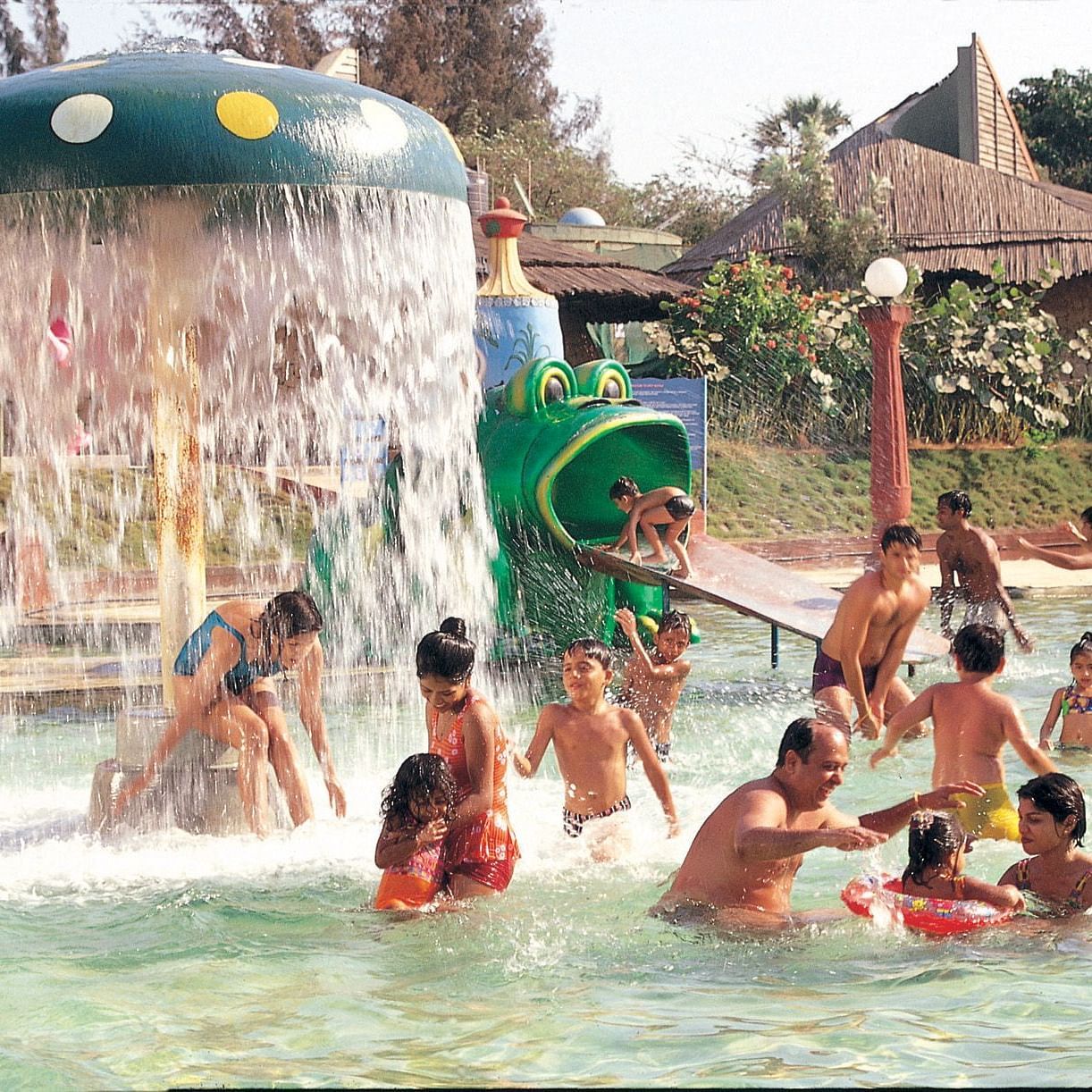 Water Kingdom - a group of children with their parents playing in a pool during daytime