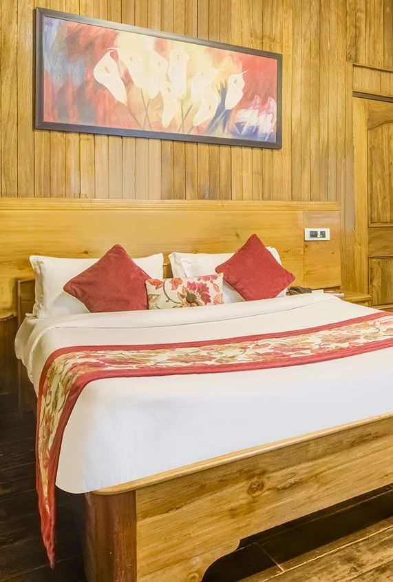 Deluxe cottage at Summit Barsana Resort & Spa, Kalimpong with a double bed