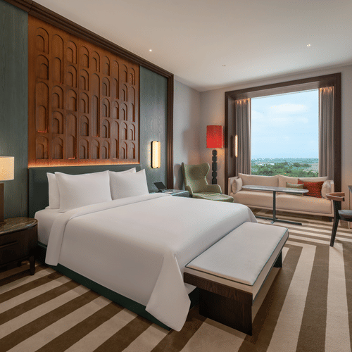 Club Room 8012 bedroom with a bed, striped rug and wooden headboard at The Residency Signature Madurai.