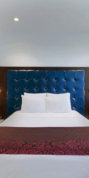 A large room with a bed and a window that overlooks the surroundings