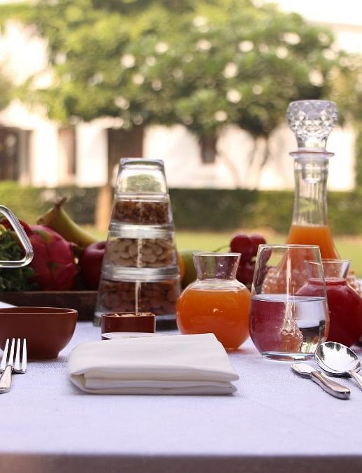 A variety of teas placed on a table with a garden in the backdrop