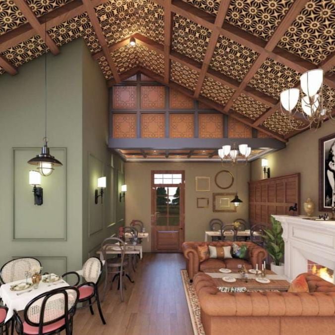 Cosy dining space featuring a high, textured ceiling, sage green accent walls, and a white fireplace at BluSalzz Terrah Hills Resort, Dalhousie.