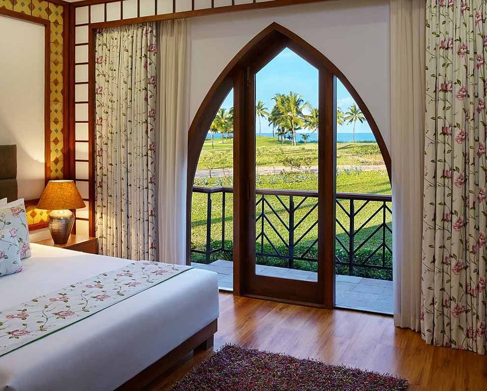 a double bed with side tables, lamps inside family villa - Caravela Beach Resort Goa