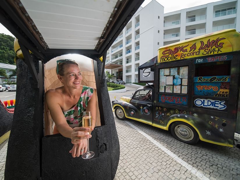 A woman enjoying the city views while sipping on champagne - S Hotel Kingston, Jamaica
