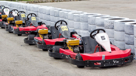 A line of red go-karts sits parked along a tyre barrier - District Gravity Adventure Park, Hyderabad