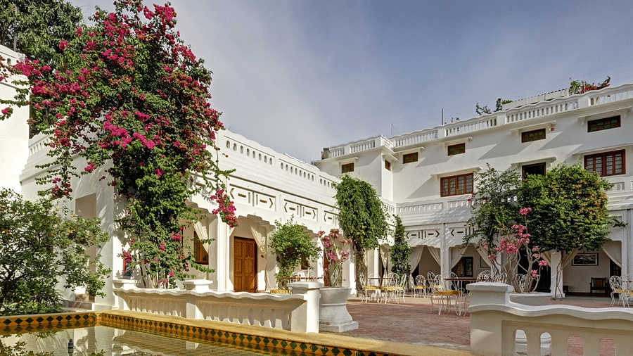 Facade of Saraca Lucknow featuring trees with flowers