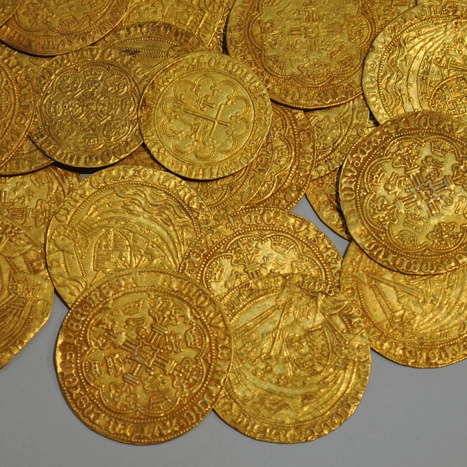 Close-up view of ancient gold coins laid out as part of a museum collection.