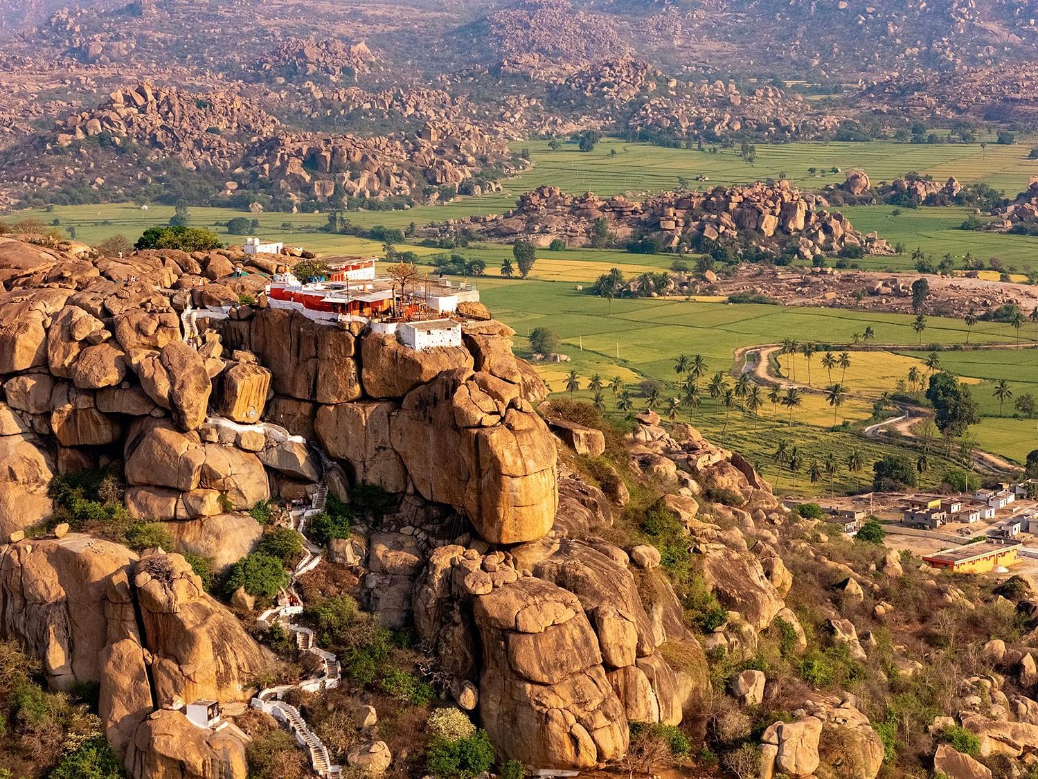 Aerial view of the rocky terrain and lush landscapes of Anegundi, part of the Anegundi Trail experience at Evolve Back, Hampi.